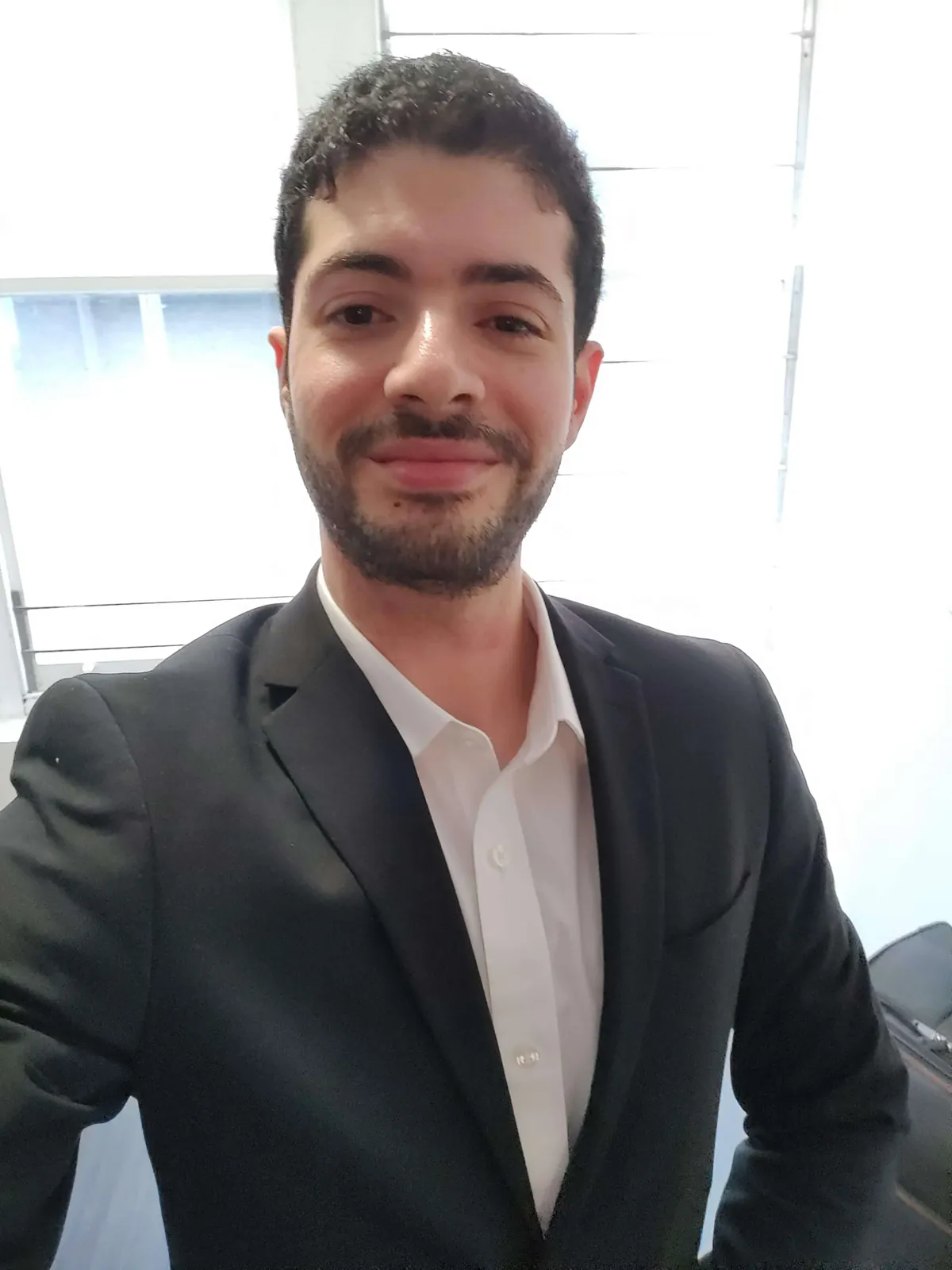 Selfie upload example for an AI clone, formal blazer and indoor lighting